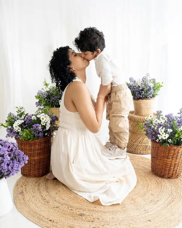 A tender kiss during a 'Mommy and Me' session. These quiet, loving moments are just as important as the big smiles, creating timeless portraits of motherhood.