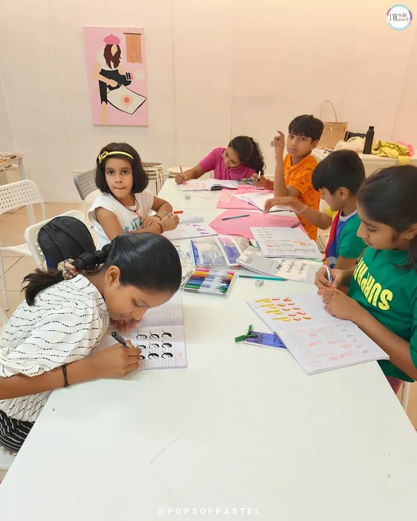 A classroom of young students diligently practicing their basic brush lettering strokes. This is where the foundation for beautiful calligraphy is built.