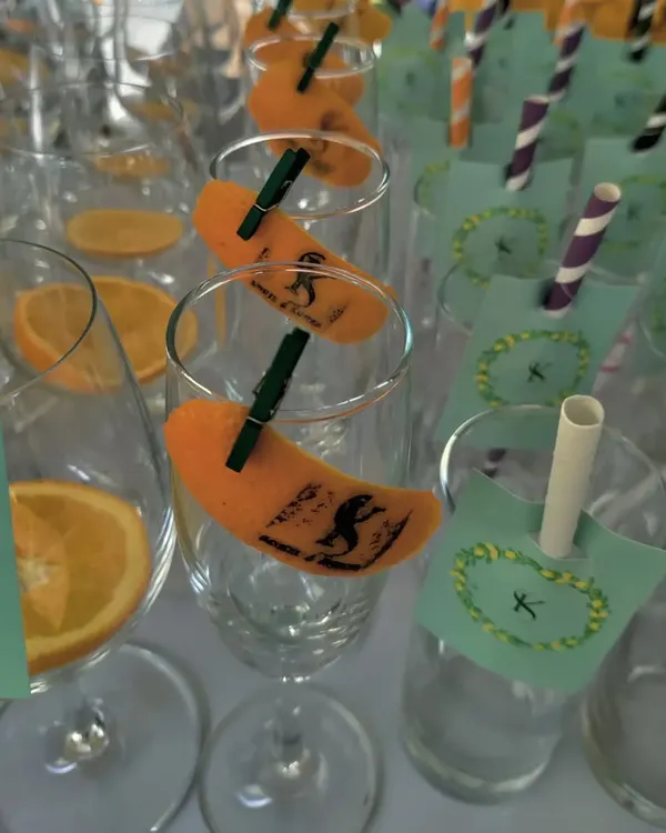 A close-up of my custom-stamped orange peels, adding a unique monogram to the rim of each glass.
