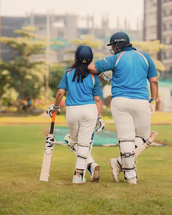 Starting their lifelong partnership on the cricket pitch. This shot captures the couple walking off the field together, a perfect metaphor for their journey ahead.