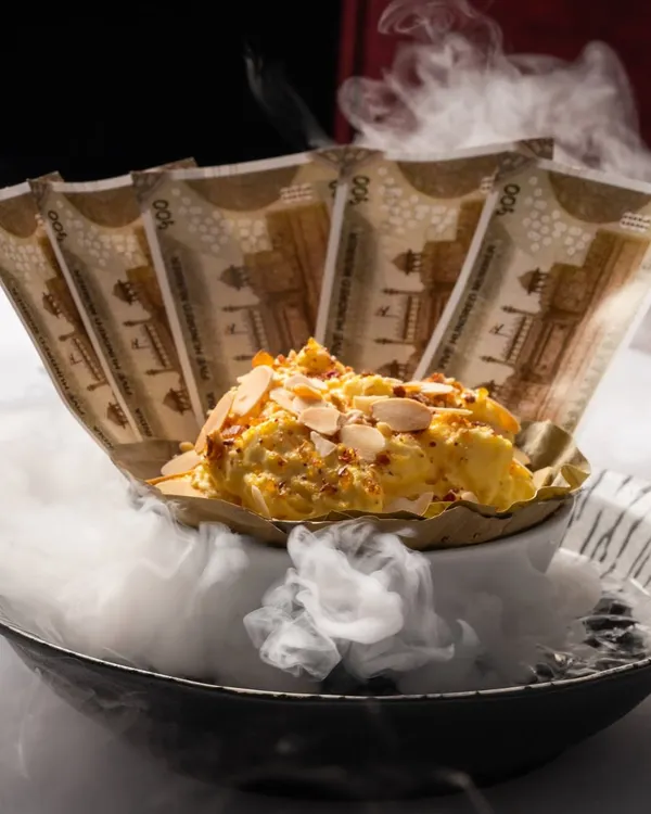 Our Daulat ki Chaat is an ethereal cloud of milk, saffron, and nuts, presented with a touch of theatre. This iconic dessert captures the magic we strive for in every dish, a fleeting moment of pure delight.