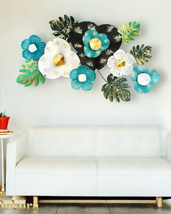 This vibrant metal flower arrangement features shades of teal, white, and black with gold centers, bringing a fresh and lively feel to this living room.