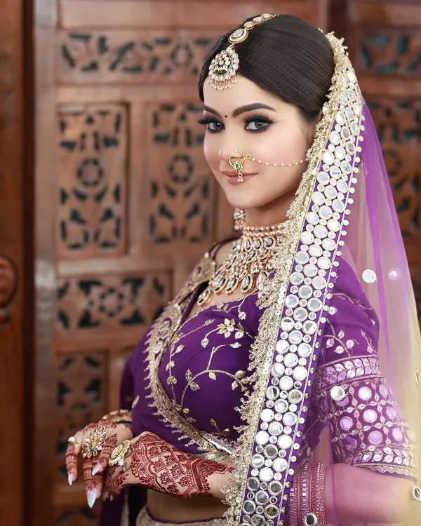 A stunning look in a purple lehenga with intricate mirror work. I created a soft glam makeup look with a flawless base to complement the outfit's modern elegance.