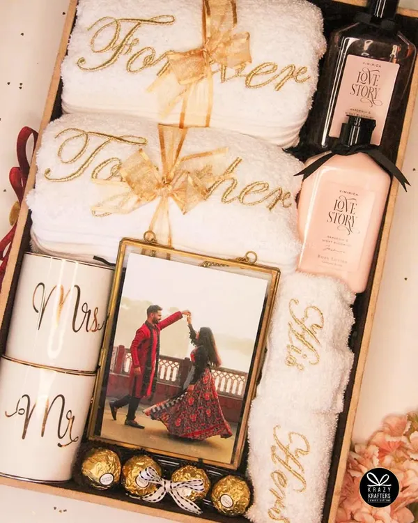 A 'Forever Together' hamper for the perfect couple. This beautiful wooden tray is filled with personalized 'His & Hers' towels, 'Mr & Mrs' mugs, a photo frame, and 'Love Story' bath products.