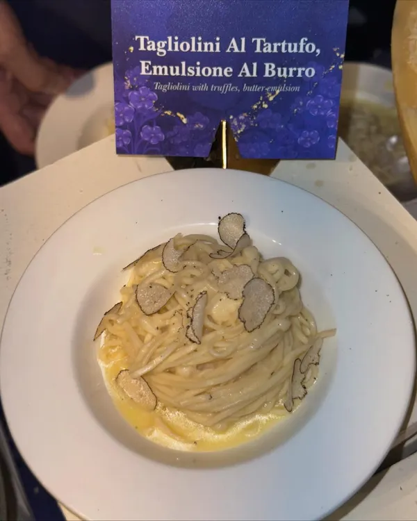 A classic Italian delight: Tagliolini Al Tartufo. This dish features fresh pasta in a butter emulsion, generously topped with shaved black truffles for an earthy, luxurious flavour.