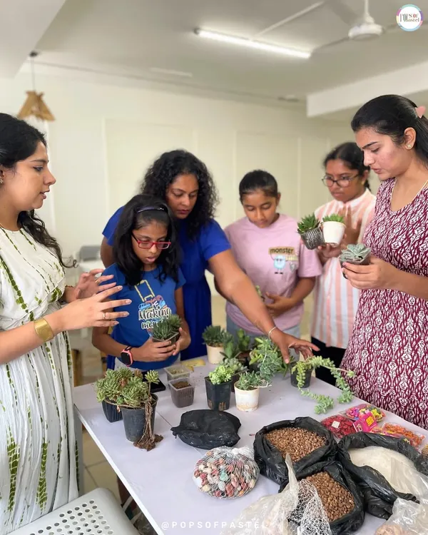 Our instructor guides a group of enthusiastic participants as they select the perfect succulents for their terrariums.