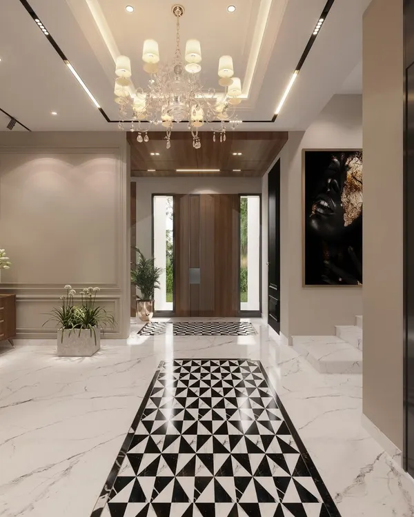 A perfect entrance sets the perfect tone. This long hallway uses a bold geometric marble inlay to guide the eye towards the main door, while a grand chandelier adds a touch of classic opulence.