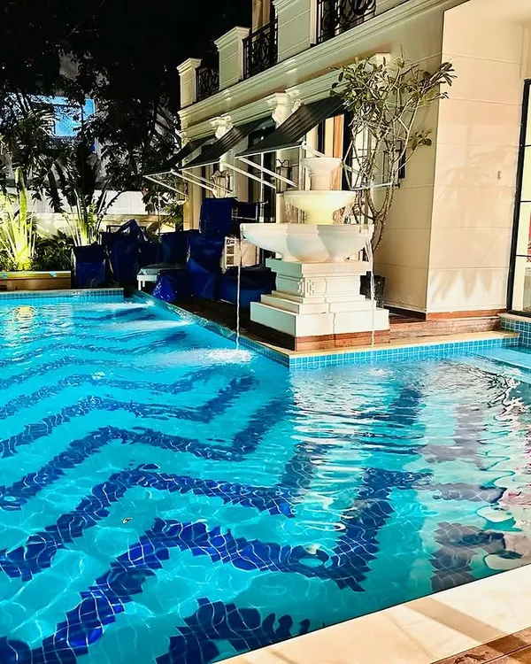 This residential pool showcases our expertise in creating luxurious and unique water features. We handled the complete execution, including the custom chevron tile pattern, integrated multi-tier fountain, and ambient underwater lighting for a stunning nighttime effect.