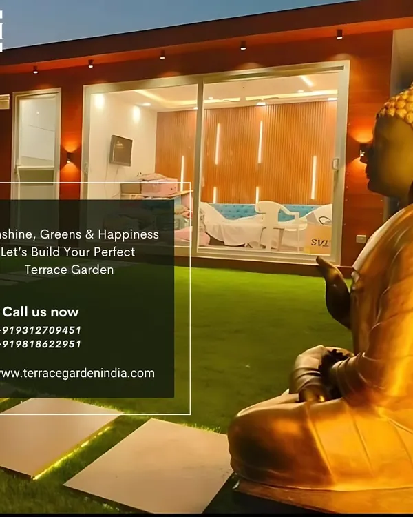 A beautiful evening shot of a completed terrace featuring a golden Buddha statue overlooking the garden, creating a space of pure sunshine, greens, and happiness.