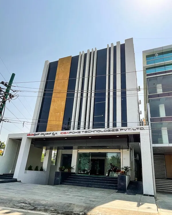This is the completed facade of our commercial project on Sarjapur Road. We designed it with bold vertical lines and a striking contrast of glass, white, and gold panels to create a strong and modern street presence for the business within.