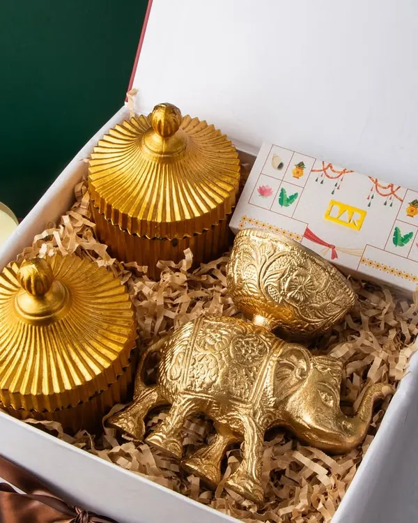 This premium Diwali hamper is a perfect example of how I blend tradition with luxury. It features ornate golden jars, a decorative brass elephant, and other handcrafted keepsakes, all beautifully arranged in a classic gift box to leave a lasting impression on your most valued clients and employees.