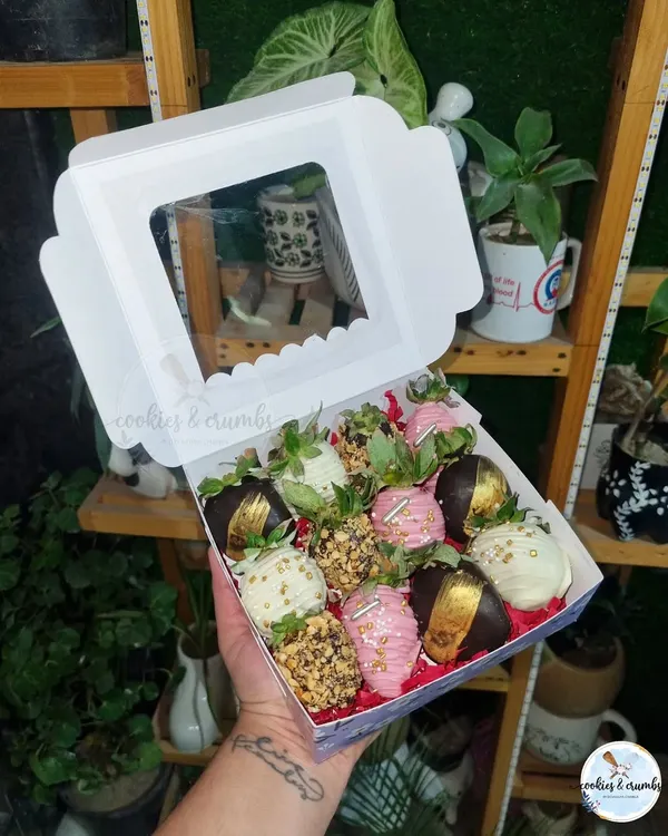 A box of my fancy chocolate-dipped strawberries. This assortment includes strawberries coated in dark chocolate with gold leaf, white chocolate, and pink chocolate with sprinkles.