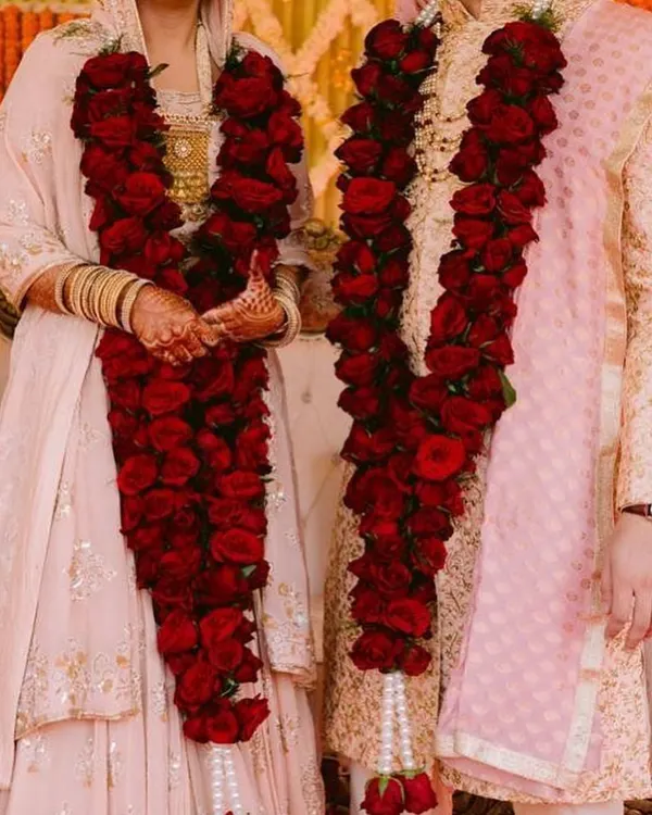 A classic jaimala made with dozens of fresh, deep red roses. I craft these dense varmalas to create a rich and timeless look for your wedding ceremony, ensuring they feel substantial and look stunning in photos.