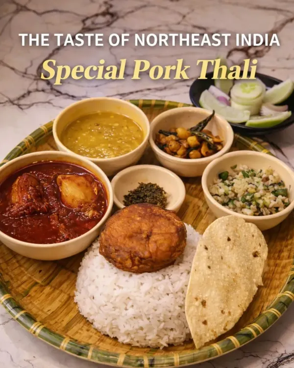 Our Special Pork Thali is a complete meal that brings you comfort and tradition on one plate. It features our signature pork curry, dal, Joha rice, a fried potato patty, fresh salad, and other sides that change daily.