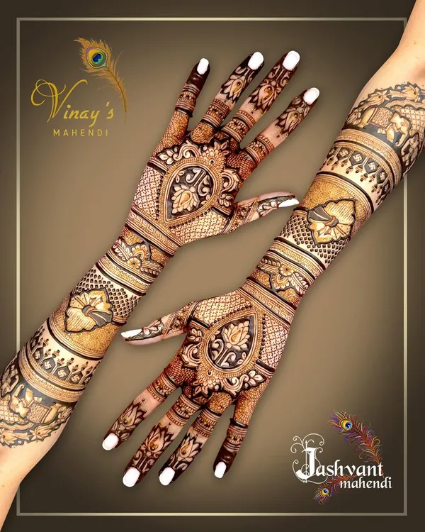 A complete view of a symmetrical back-of-hand design. The pattern flows from the elbow to the fingertips, featuring lotus and paisley motifs for a classic bridal look.