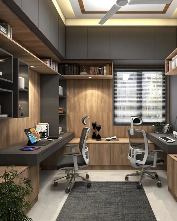 A dedicated home office designed for two people. The space features dual workstations, ergonomic chairs, and extensive overhead and side storage, ensuring a productive and organized work environment.