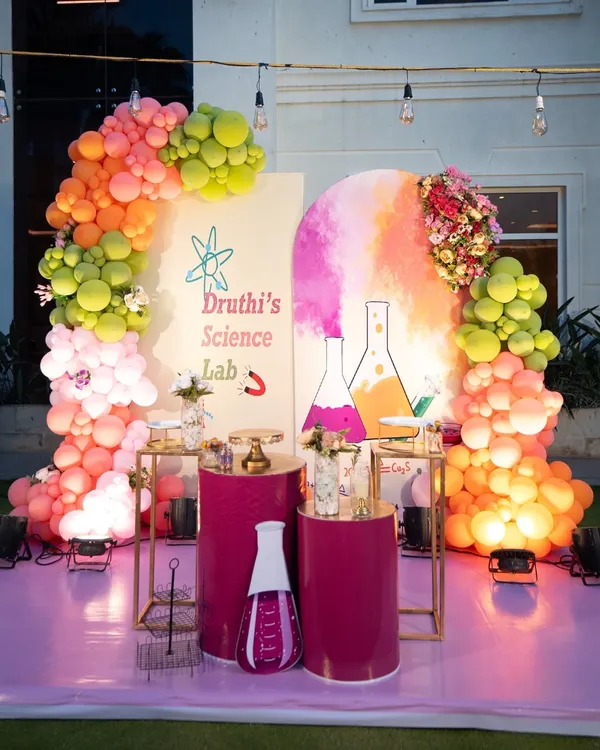 A creative and colorful "Science Lab" theme for a curious birthday kid. This setup features a vibrant balloon arch, custom backdrops with flask illustrations, and themed props to create a fun, educational party atmosphere.