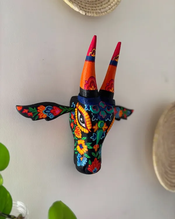 This Nandi, with its burst of floral color, is inspired by the exquisite 'aari' embroidery of Kashmir. It's a perfect example of how I love to translate the beauty of Indian textiles and folk art onto a three-dimensional wooden canvas, making it a unique piece of wall decor.