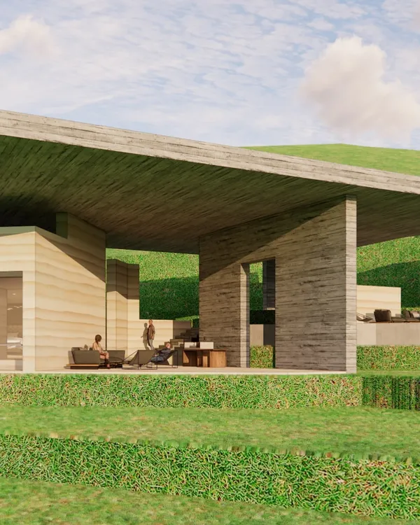 A design for an informal gathering space at a retreat in Almora. The structure uses rammed earth walls and a large concrete overhang to create a sheltered outdoor area that feels connected to the vast mountain landscape.
