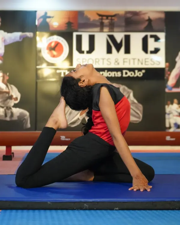 Flexibility is just as important as strength. Here, a student demonstrates an advanced yoga pose, showcasing the balance and control we cultivate.