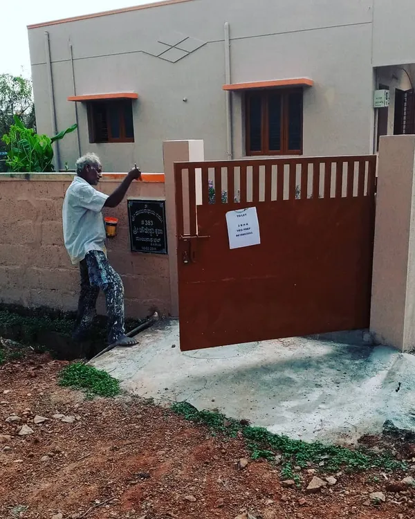 Here I am applying the final touches to a freshly painted metal gate. A proper paint job on exterior metal is essential for preventing rust and keeping your entrance looking sharp.