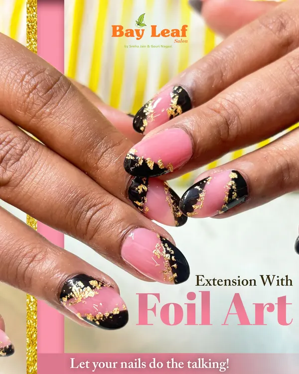 A bold and luxurious look featuring almond-shaped nail extensions with a modern pink and black design, highlighted by delicate gold foil art for a touch of glamour.