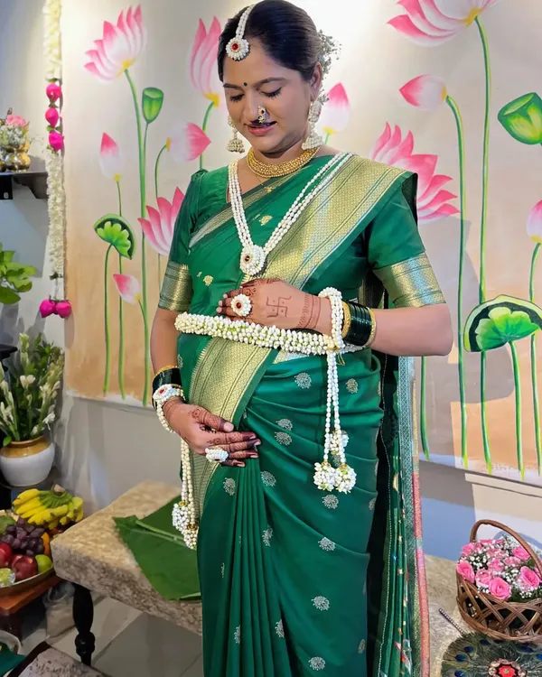 A serene moment from a baby shower. I draped this green silk saree with special care to ensure it was comfortable for the mother-to-be, using techniques that provide support and elegance.
