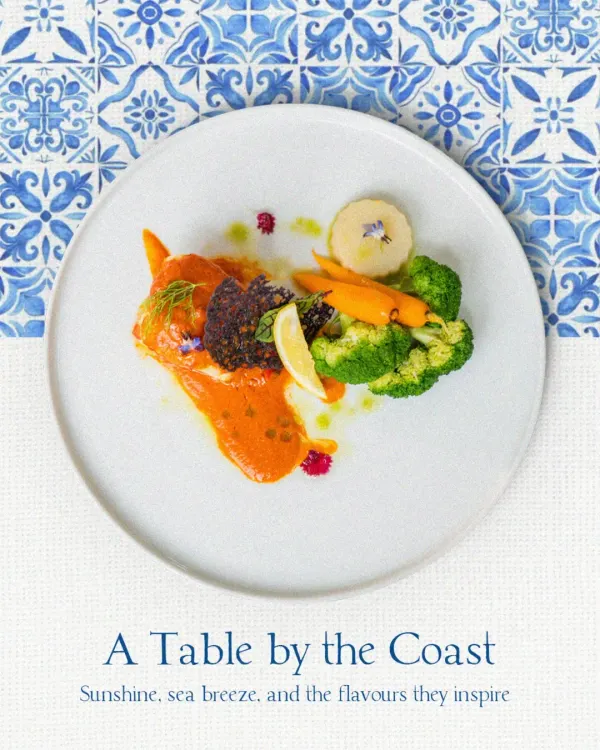 A beautifully plated fish dish with a vibrant orange sauce and fresh vegetables. This plate represents our philosophy of using fresh, seasonal ingredients inspired by the coast.