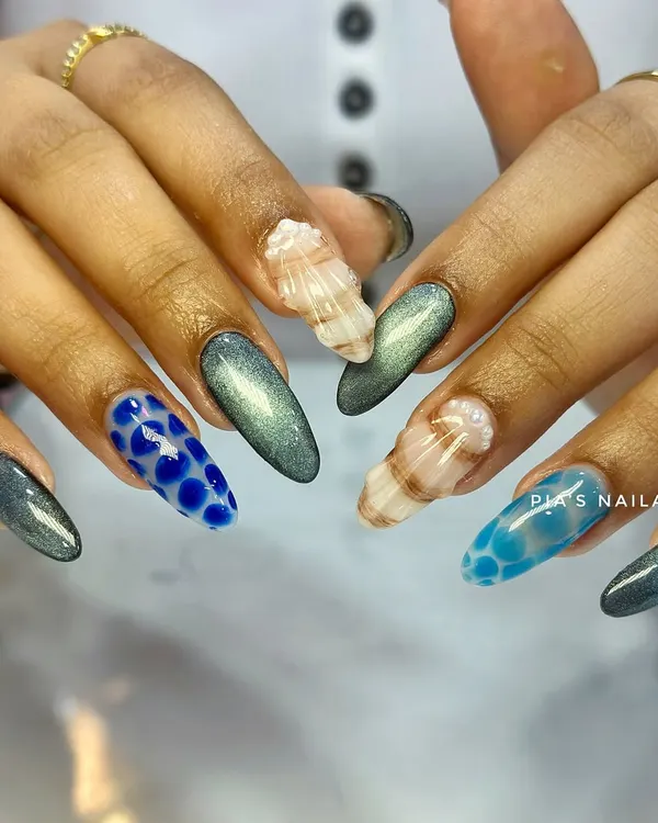 A full look at this textured, ocean-inspired set. You can see the sculpted 3D seashells, the raised water droplet effect, and the shimmering cat eye polish all working together.