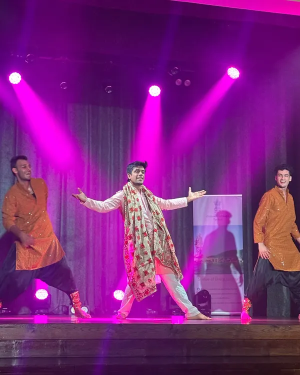 We make sure the groom and his friends own the stage. This photo captures the joy and energy of a Bollywood group performance, a perfect addition to any sangeet or wedding celebration.