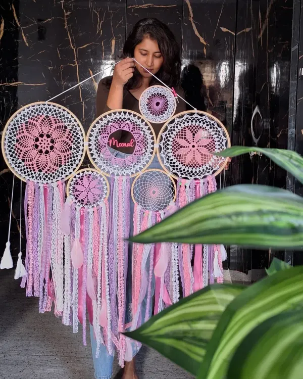This personalized pink cluster dreamcatcher, featuring the name 'Meenal', was designed to radiate warmth and positivity. It's a perfect example of our large-scale, custom wall hangings.