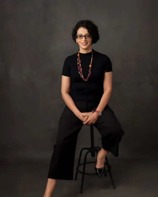 A professional portrait should radiate confidence and approachability. Here, we used a classic seated pose against a textured backdrop to create a headshot that is both strong and engaging, perfect for making a great first impression.
