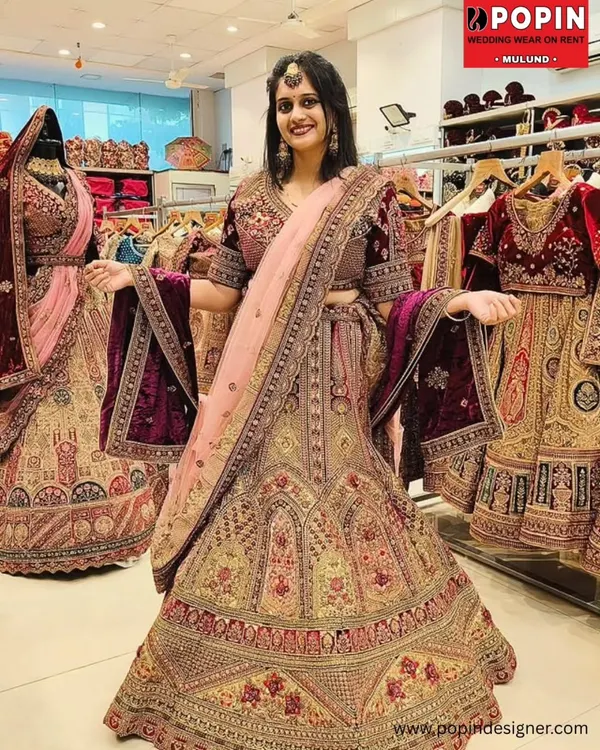 This heavily embroidered velvet lehenga is for the bride who dreams of a royal and timeless wedding day look. The intricate gold work and rich maroon fabric create a breathtaking silhouette, making you the star of your own fairytale.