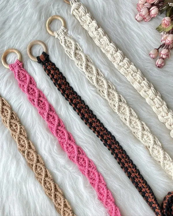 My handmade macrame belts, perfect for adding a bohemian touch to any outfit. Pictured here are five different color options, from neutral off-white and earthy brown to bold pink, each featuring a beautiful knotted pattern and a smooth wooden ring buckle. I can customize the size and color for a perfect fit.