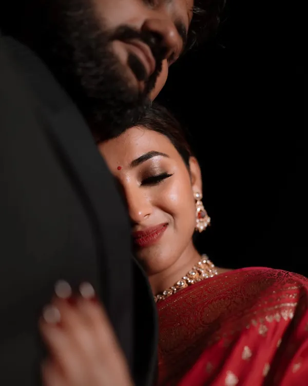 A close-up portrait capturing a moment of pure contentment and love. This intimate shot focuses on the bride's serene expression as she rests in her partner's embrace.