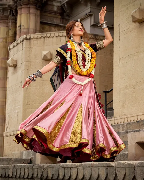 A vibrant and energetic look styled for a Navratri campaign. The pink and gold lehenga is perfect for garba, styled with traditional silver jewellery and a floral garland for an authentic touch.
