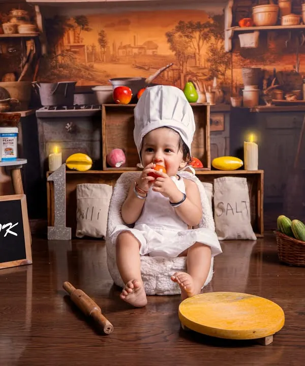 A full view of the 'Little Chef' setup, featuring a rustic kitchen backdrop, miniature sacks of flour and salt, and a personalized slate. This baby is ready to cook up some cuteness.
