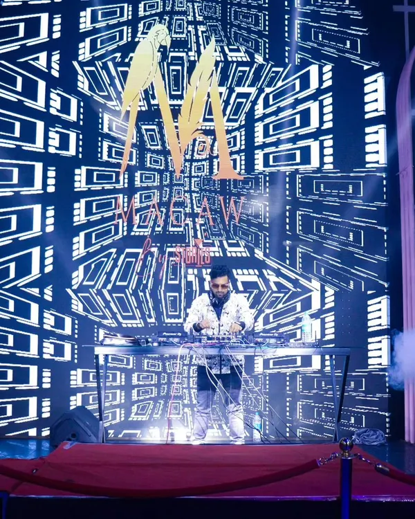 This is my signature VDJ setup. I command the stage with a massive LED screen displaying custom visuals and my logo, turning any DJ console into a main attraction.