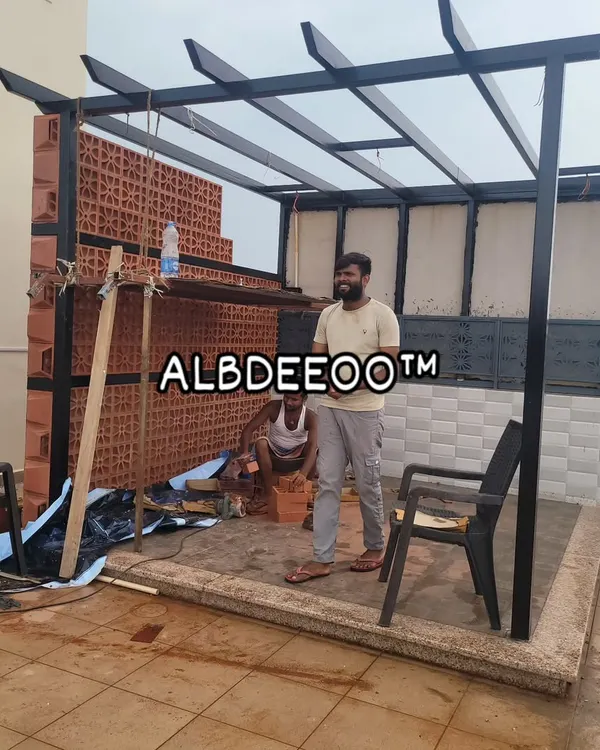 My team at work on a custom terrace pergola. This shot shows the black mild steel frame being erected and the start of a beautiful terracotta jali brick wall, which adds a traditional touch and privacy.