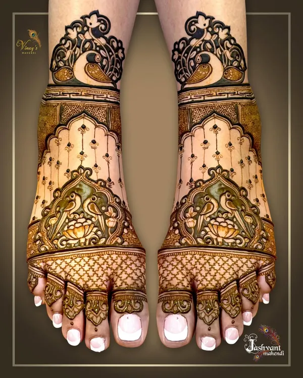 An elegant bridal feet design featuring parrots and lotus motifs. The use of negative space and delicate dot work gives it a light and graceful feel.
