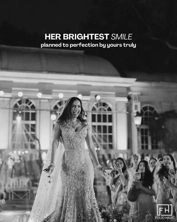 Her brightest smile, planned to perfection. This black and white shot captures the pure, uninhibited joy of a bride on her special day, a moment of happiness that we work tirelessly to create.