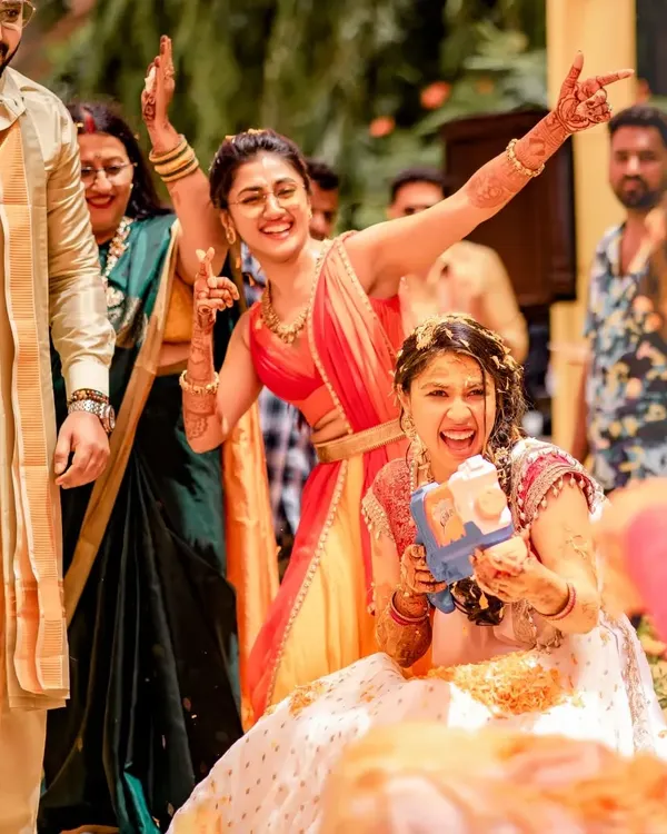 The Haldi is pure joy. Here I am with my sister, sharing a laugh during the celebrations. I love helping families create these fun, spontaneous moments of dance and connection.