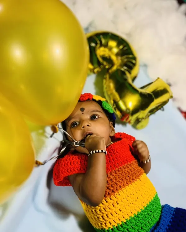 A beautiful client photo featuring my rainbow frock and matching headband. The bright, cheerful colors make this a wonderful outfit for birthday photoshoots or any happy celebration.