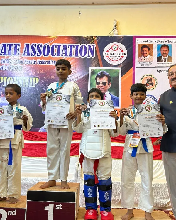 Our students proudly display their medals and certificates on the podium at the State Level Championship in Hubli. This is the reward for their dedication to both kata and kumite.
