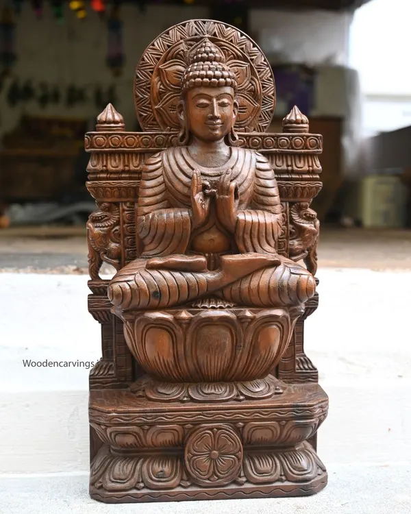 A 24-inch Lord Buddha statue, handcrafted with a wax brown finish. Depicted in the Dharmachakra mudra for teaching, this sculpture is perfect for creating a space of peace and learning in your home.