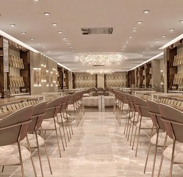 An expansive view of a luxury gold jewellery showroom we redesigned. The long, symmetrical layout, combined with consistent lighting and elegant seating, creates a grand and immersive customer journey from the moment they enter.