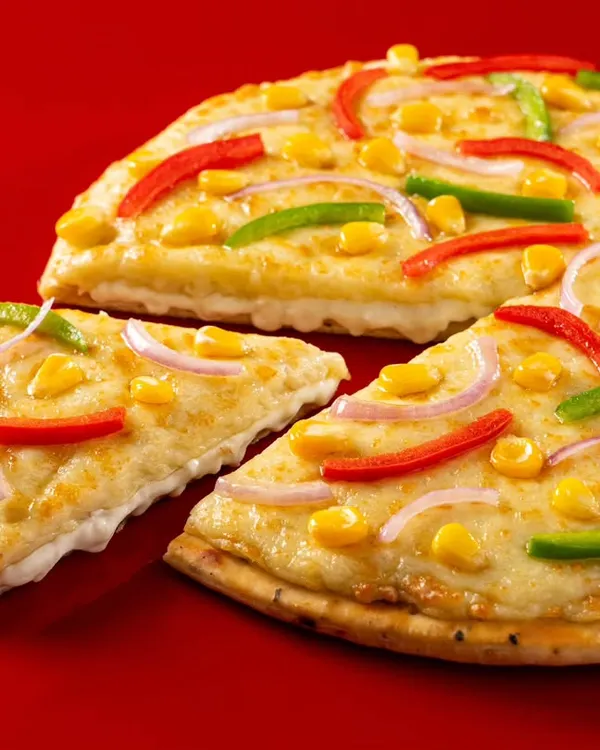 A classic, clean shot of a vegetable pizza for Ovenstory. The bright red background makes the product pop, and the perfect slice pull makes it ideal for menus and ads.