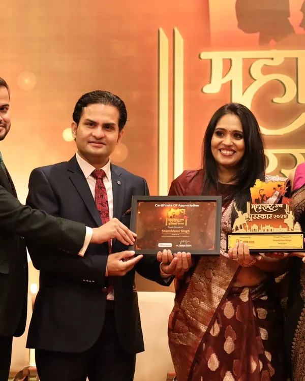 Receiving the Maharashtra Ratan Puraskar award on stage. This state-level recognition in my home of Mumbai is a deeply meaningful milestone in my 26-year journey as a healer and life coach.
