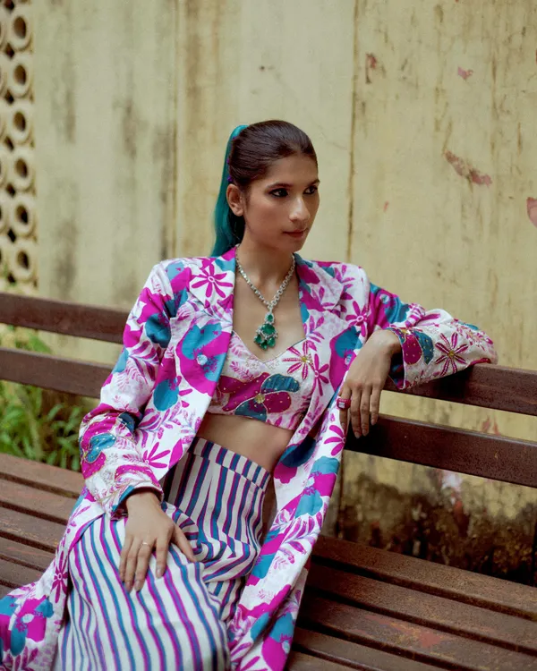 This look is from my festive lookbook, playing with print-on-print and a bold teal wig. I love pushing boundaries and creating festive looks that are anything but boring.