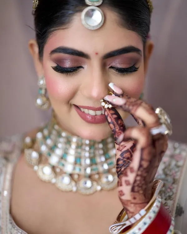A close-up of Disha's beautiful Pheras makeup. I created a soft smokey eye with a hint of shimmer and a rosy nude lip to complement her stunning pastel lehenga. It’s all about those delicate details that bring the whole look together.